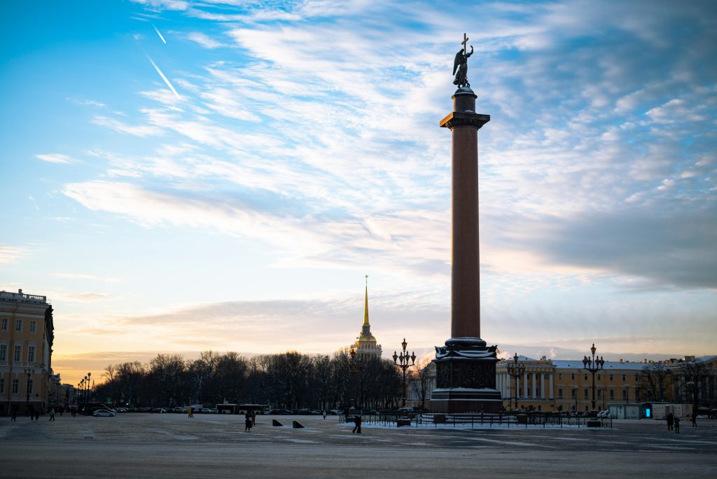 Stunning view of Alexander Column in Saint Petersburg at sunset with vibrant sky.