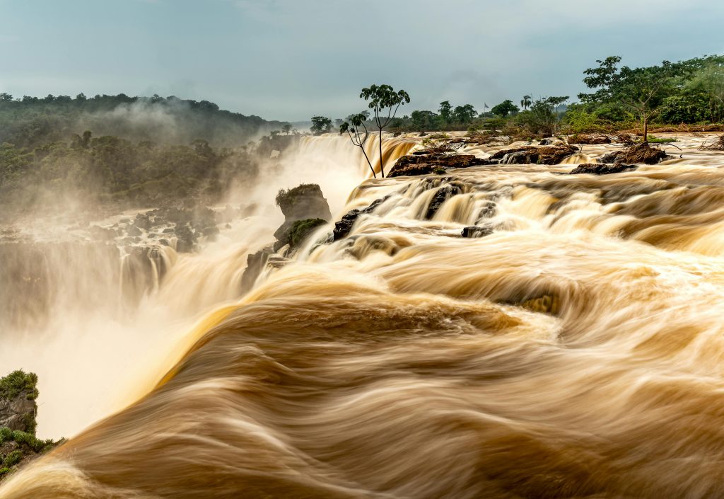 Majestic view of Iguazú Falls in Argentina, showcasing powerful cascading waters and lush greenery.