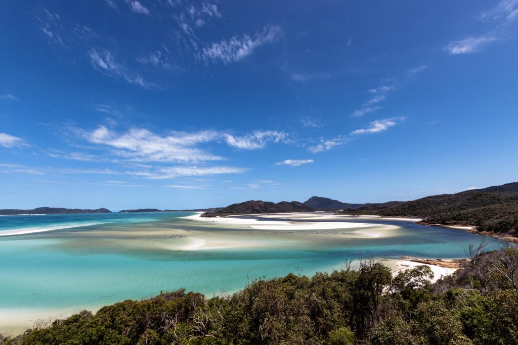 A breathtaking view of the serene Whitsundays beach with turquoise waters in Queensland, Australia.